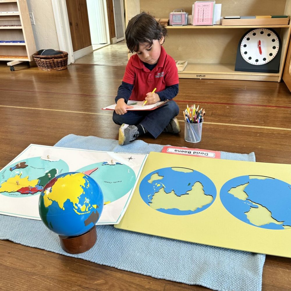 Sunset Montessori school kid learning world map